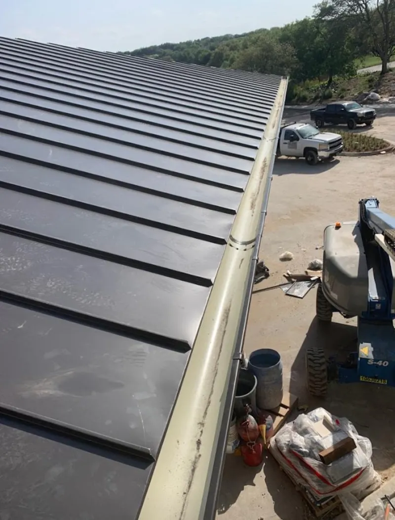 Standing seam panel and gutter detail on a metal roofing jobsite in Reading